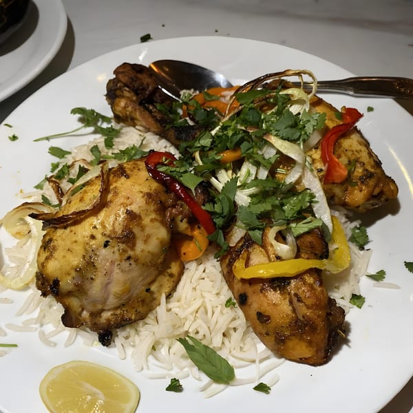 Taj Mahal Homestyle Indian and Pakistani Cuisine's chicken tikka with rice, bell peppers, onions, and cilantro.